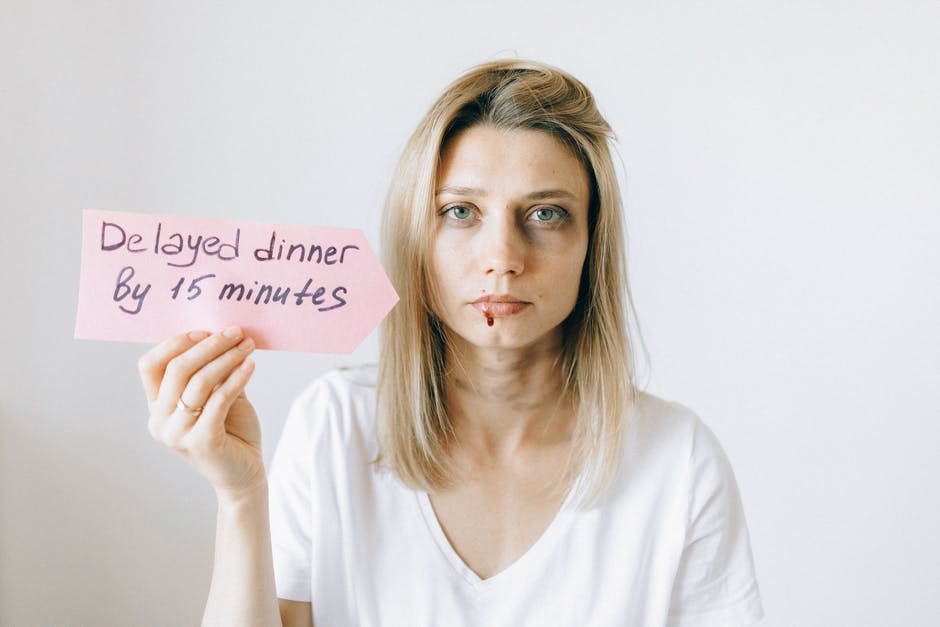 intimate partner violence - woman holding a sign