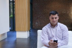 man looking at cell phone