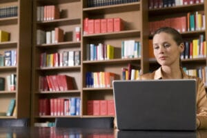 professional on a laptop in a library