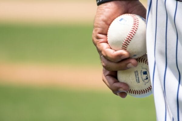 pitcher holding baseballs