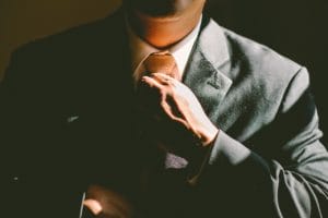 decisive attorney straightening his tie