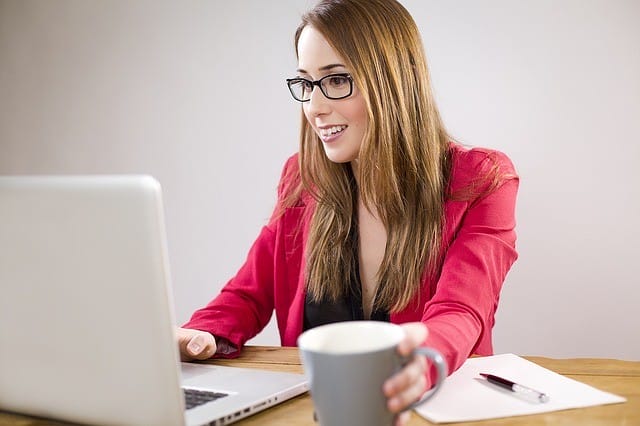 girl at computer showing why LNCs need a website