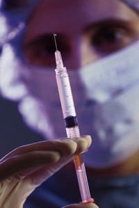 healthcare professional holding syringe