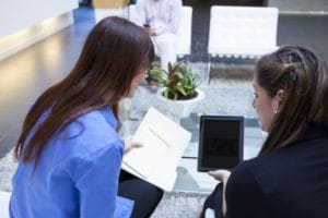 two women looking at Ipad